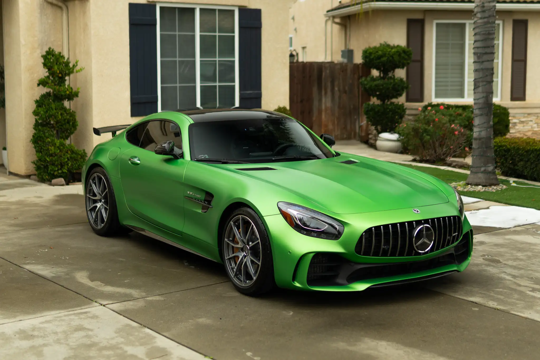 A green Mercedes-AMG GT R detailed to a flawless satin finish in a Central Valley driveway
